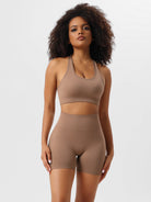 Woman wearing a brown seamless workout set, featuring a sports bra and high-waisted shorts, ideal for yoga and fitness. Comfortable activewear.