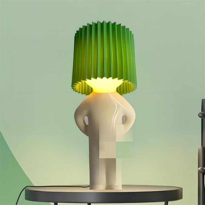 Unique modern table lamp with green pleated shade and abstract white base on a round table, contemporary home decor lighting accessory.