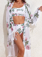 Woman in floral bikini and sheer kimono with fringe, showcasing summer beachwear fashion. Stylish swimwear outfit for tropical vacations.