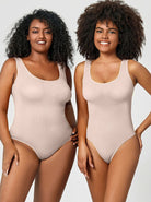 Two women wearing beige seamless bodysuits, smiling, showcasing comfortable, stylish shapewear. Perfect for everyday wear and body confidence.