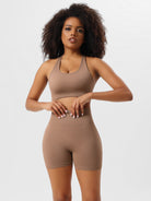 Woman in brown seamless workout set, featuring a sports bra and high-waisted shorts, ideal for yoga and fitness. Comfortable activewear for women.