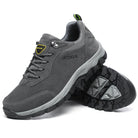 Gray outdoor hiking shoes with durable rubber soles, breathable mesh, and lace-up design. Ideal for trekking and outdoor activities.