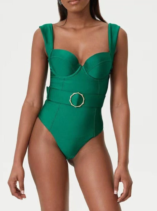 Green belted one-piece swimsuit with structured cups, wide straps, and a gold buckle. Perfect for beachwear and summer fashion trends.