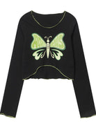 Black long-sleeve crop top featuring a green butterfly design with "Aquarius" text. Trendy astrology-themed fashion, perfect for casual wear.