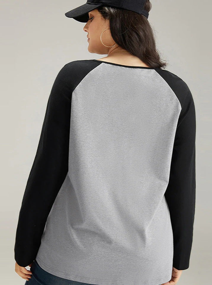 Woman wearing a gray and black raglan long-sleeve shirt with a black cap, viewed from the back. Casual fashion, plus size clothing, stylish outfit.