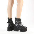 Black platform combat boots with silver chain details, chunky heels, and lace-up design. Trendy women's footwear for edgy fashion styles.