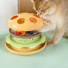 Cat playing with interactive toy featuring multiple layers and a spinning ball. Perfect for pet entertainment and mental stimulation.