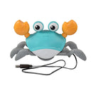 Toy crab with USB charger, blue and gray body, orange claws, and googly eyes. Ideal for kids' bath time fun. Battery-powered bath toy.