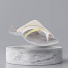 Women's ergonomic flip-flop sandal with arch support, featuring a gray sole and white straps with yellow accents, ideal for comfortable summer wear.