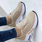 Women's orthopedic comfort sneakers in beige with white soles, featuring breathable mesh and stylish design. Ideal for casual wear and foot support.