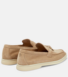 Tan suede loafers with white rubber soles, featuring a minimalist design and subtle stitching. Perfect for casual wear. Men's footwear fashion.