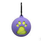 Purple pet accessory with paw print design, featuring a yellow tennis ball inside. Includes a black carabiner clip. Ideal for dog toys and pet gear.