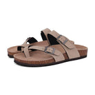 Beige leather sandals with adjustable buckles, cork footbed, and rubber sole. Comfortable, stylish footwear for casual wear. Perfect for summer.