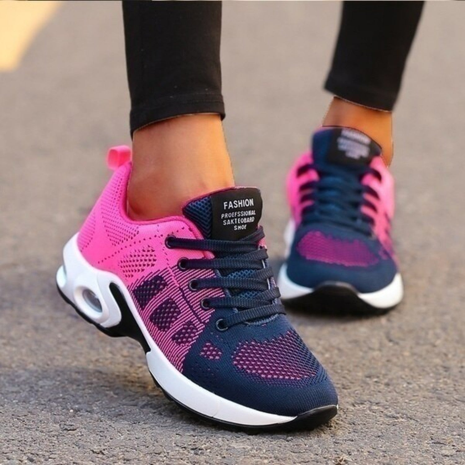 Pink and navy blue women's athletic sneakers with breathable mesh design, cushioned sole, and lace-up closure, ideal for running and casual wear.