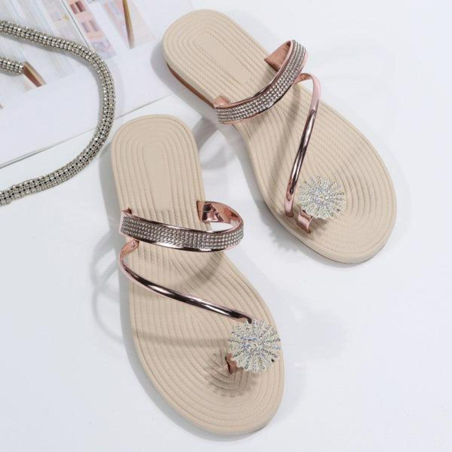 Elegant beige women's sandals with rhinestone embellishments and metallic straps, perfect for summer fashion and casual wear.