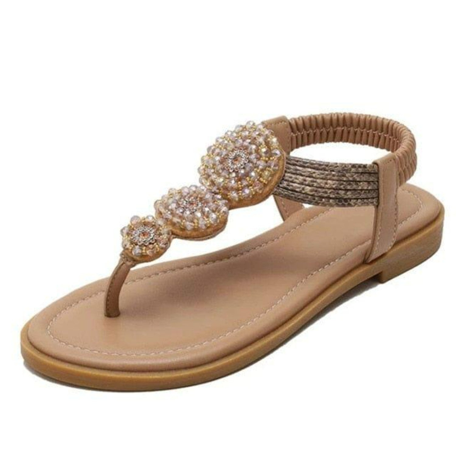 Beige women's sandal with rhinestone embellishments, elastic ankle strap, and flat sole. Stylish summer footwear, perfect for casual wear.