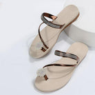 Elegant beige women's sandals with rhinestone-studded straps and floral embellishments, perfect for summer fashion and casual wear.