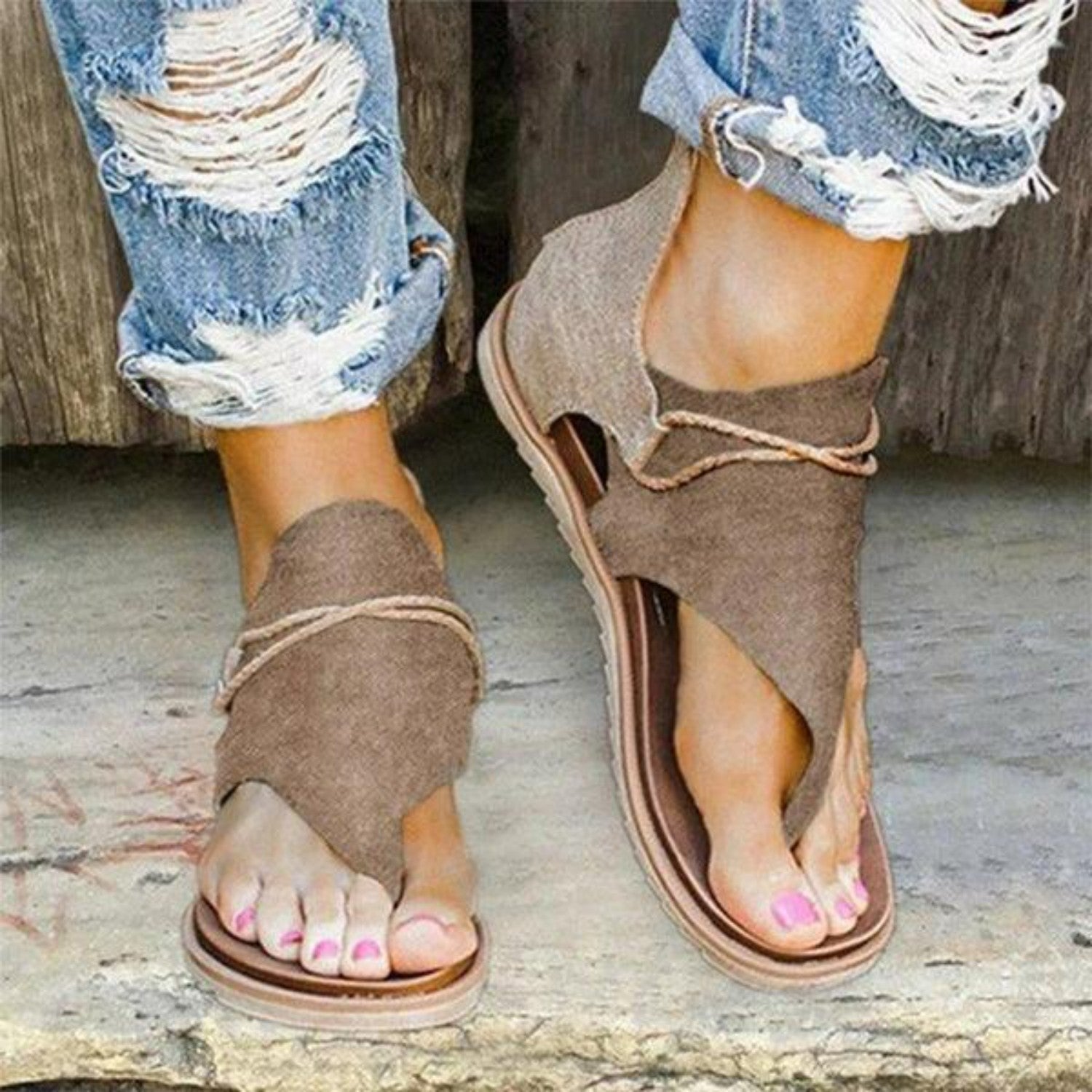 Women's casual open-toe sandals with brown fabric straps, paired with distressed denim jeans. Perfect for summer fashion and comfortable footwear.