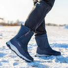 Winter boots on person walking in snow, featuring durable soles and insulated design. Ideal for cold weather, outdoor activities, and snow protection.