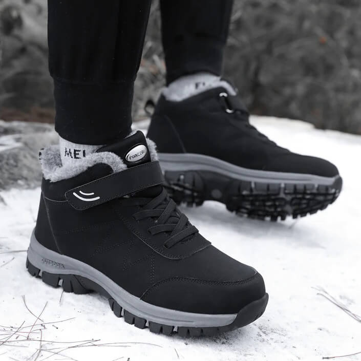 Black winter hiking boots with fur lining, durable rubber soles, and Velcro strap, designed for snow and outdoor activities.