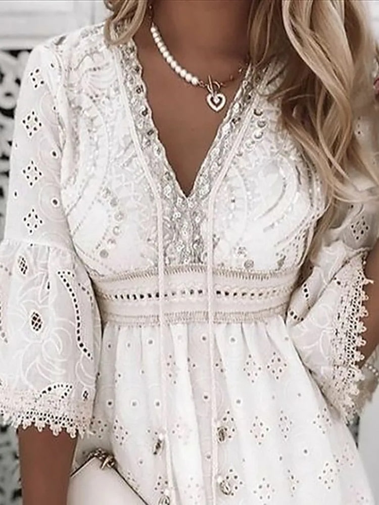 Elegant white lace dress with intricate embroidery, featuring a V-neckline and puff sleeves. Perfect for summer fashion and boho-chic style enthusiasts.
