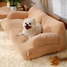 Small white dog sitting on a plush beige pet sofa in a cozy room with soft lighting, fluffy carpet, and indoor plants. Perfect pet furniture.