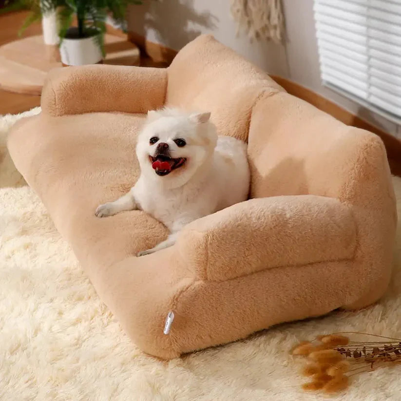 Small white dog sitting on a plush beige pet sofa in a cozy room with soft lighting, fluffy carpet, and indoor plants. Perfect pet furniture.