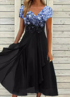 Elegant black evening dress with a floral-patterned blue sequin top, V-neckline, and flowing skirt, perfect for formal occasions and parties.