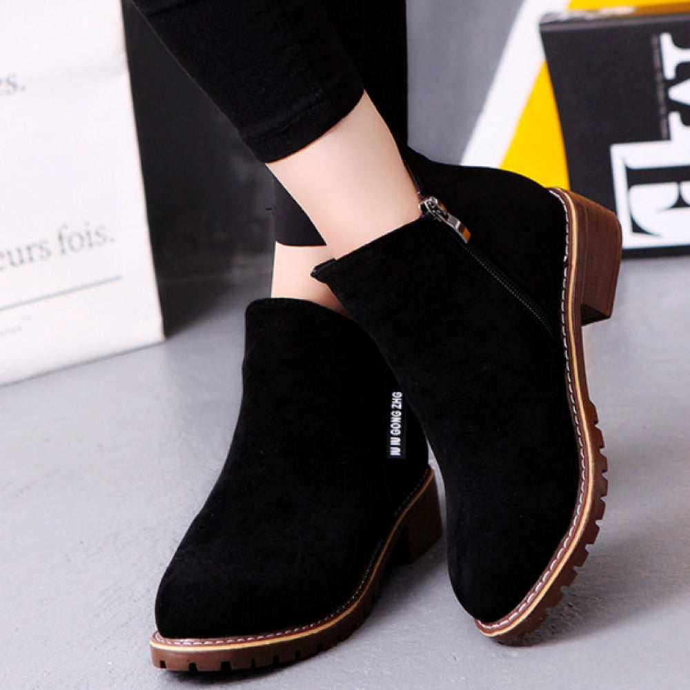 Black suede ankle boots with side zipper, chunky brown sole, and casual design. Perfect for women's fall fashion and comfortable everyday wear.