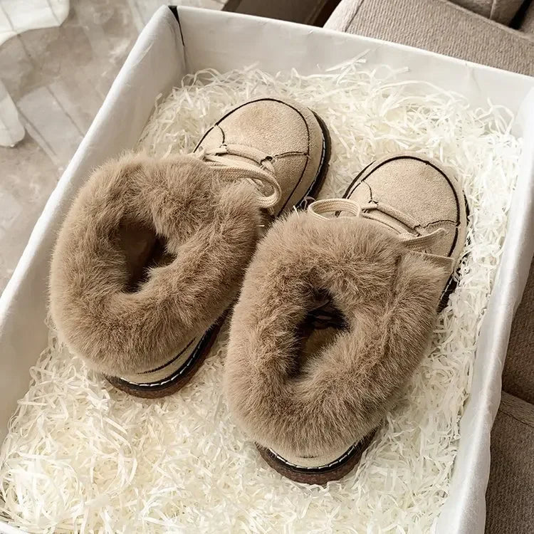 Cozy beige fur-lined slippers in a gift box, perfect for winter warmth. Soft, plush design ideal for indoor comfort. Great holiday gift idea.