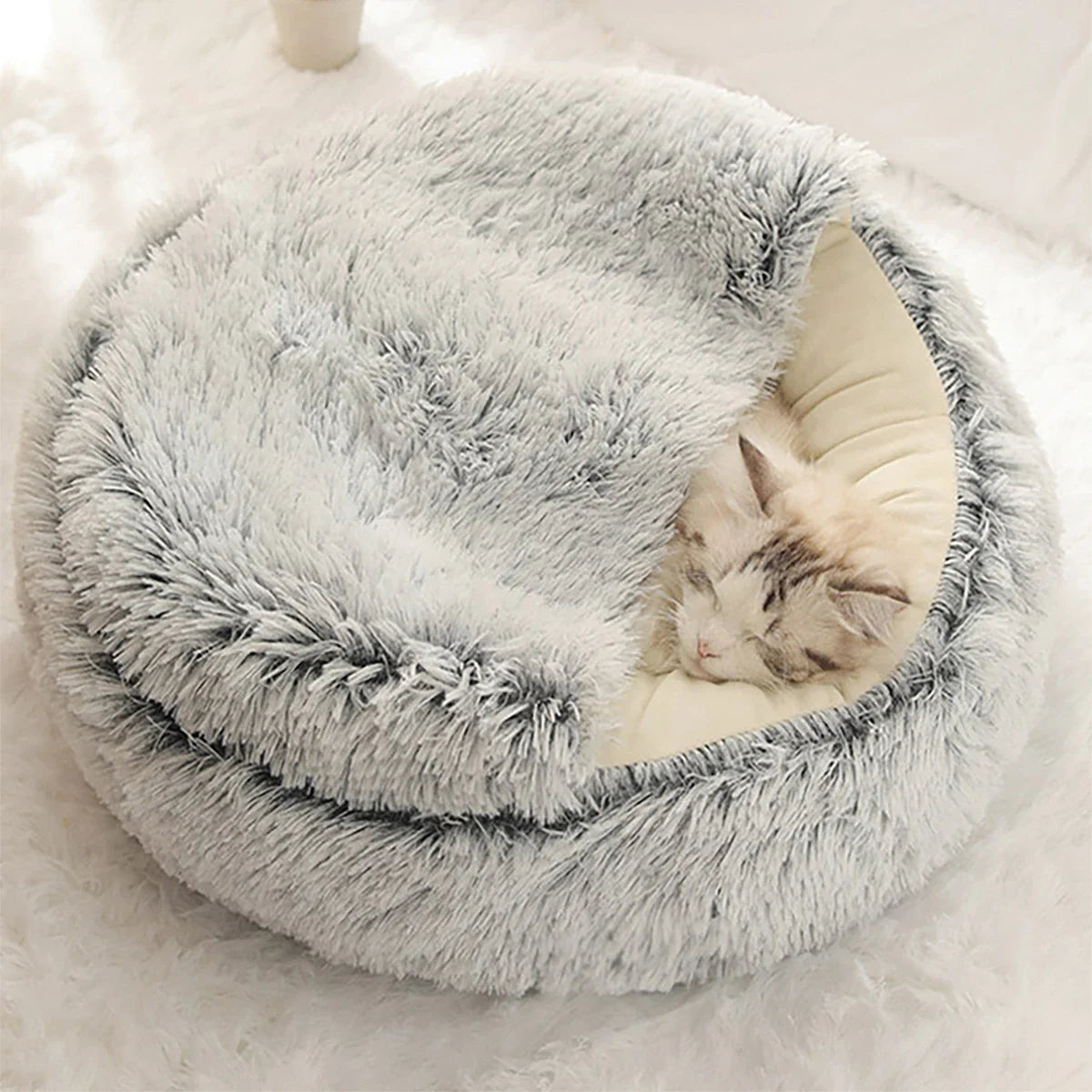 Fluffy gray cat bed with sleeping cat, cozy pet furniture, soft plush material.