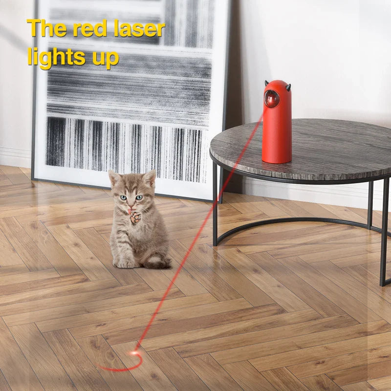 Cat playing with automatic red laser toy on wooden floor, modern home decor, interactive pet entertainment, kitten engaged with laser beam.