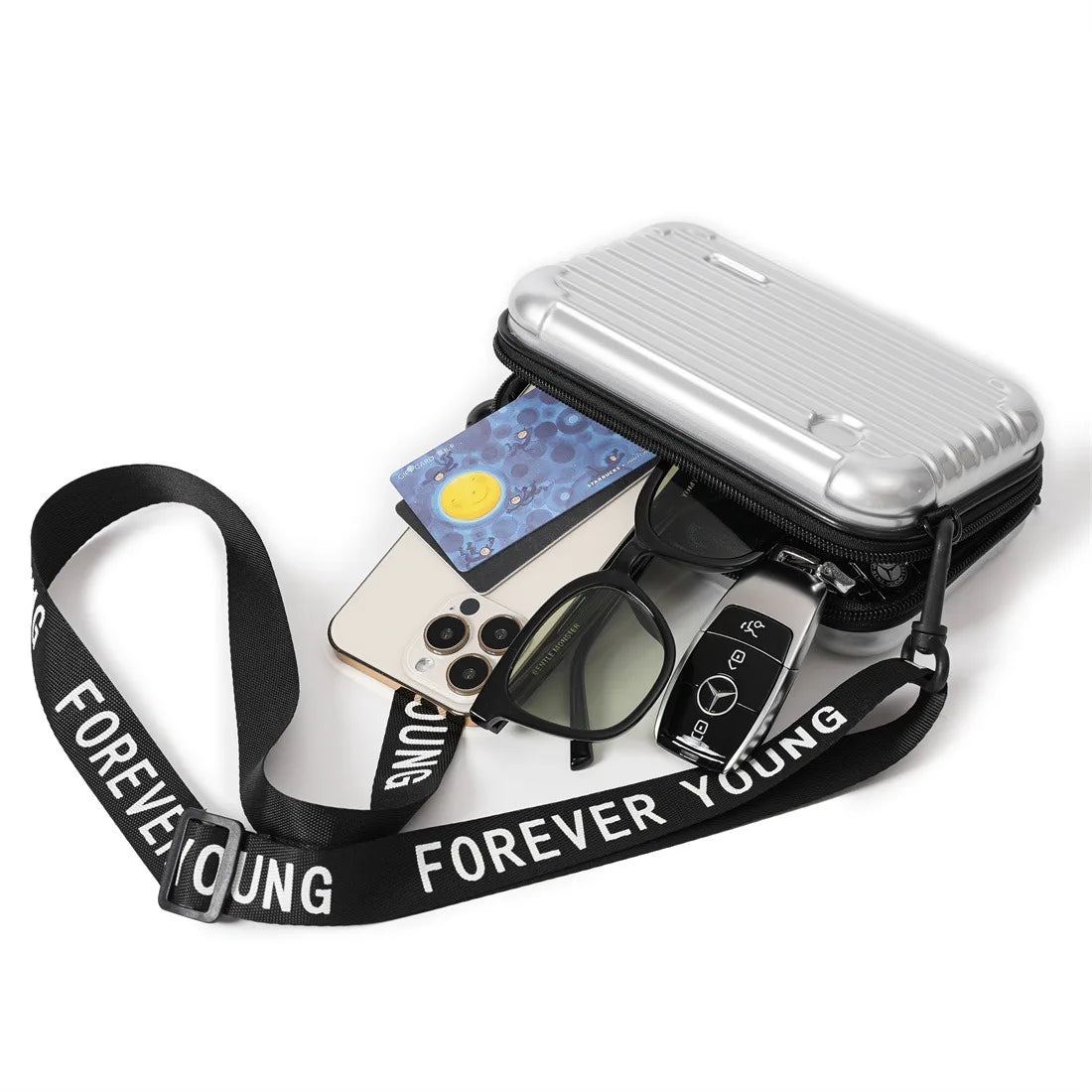 Silver mini crossbody bag with "Forever Young" strap, featuring smartphone, sunglasses, credit card, and car key. Stylish and compact accessory.