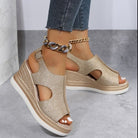 Gold glitter wedge sandals with open-toe design, ankle strap, and chain anklet. Stylish women's footwear, perfect for summer fashion and casual outfits.