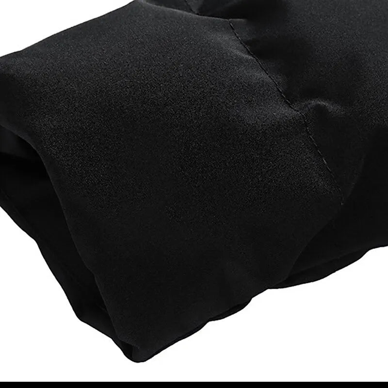 Black puffer jacket sleeve, insulated winter coat, durable fabric, close-up view.