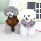 Two adorable poodles in stylish winter coats, one gray and one white, sitting indoors. Perfect pet fashion for small dogs. Cozy, cute, and trendy.