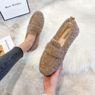 Women's cozy brown faux fur loafers on a white rug, featuring a plush interior and slip-on design. Perfect for casual winter fashion and comfort.