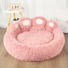 Pink fluffy pet bed shaped like a paw, cozy and soft, perfect for cats and small dogs.