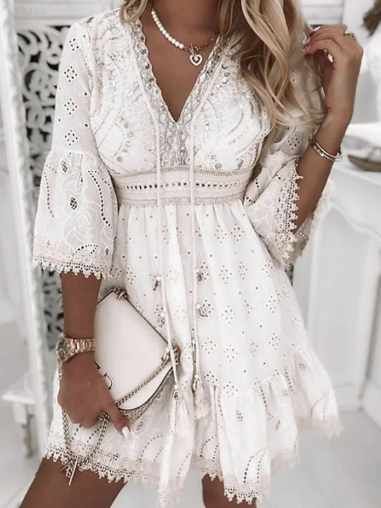Elegant white lace dress with intricate embroidery, V-neckline, and bell sleeves. Perfect for summer fashion, boho style, and casual chic outfits.