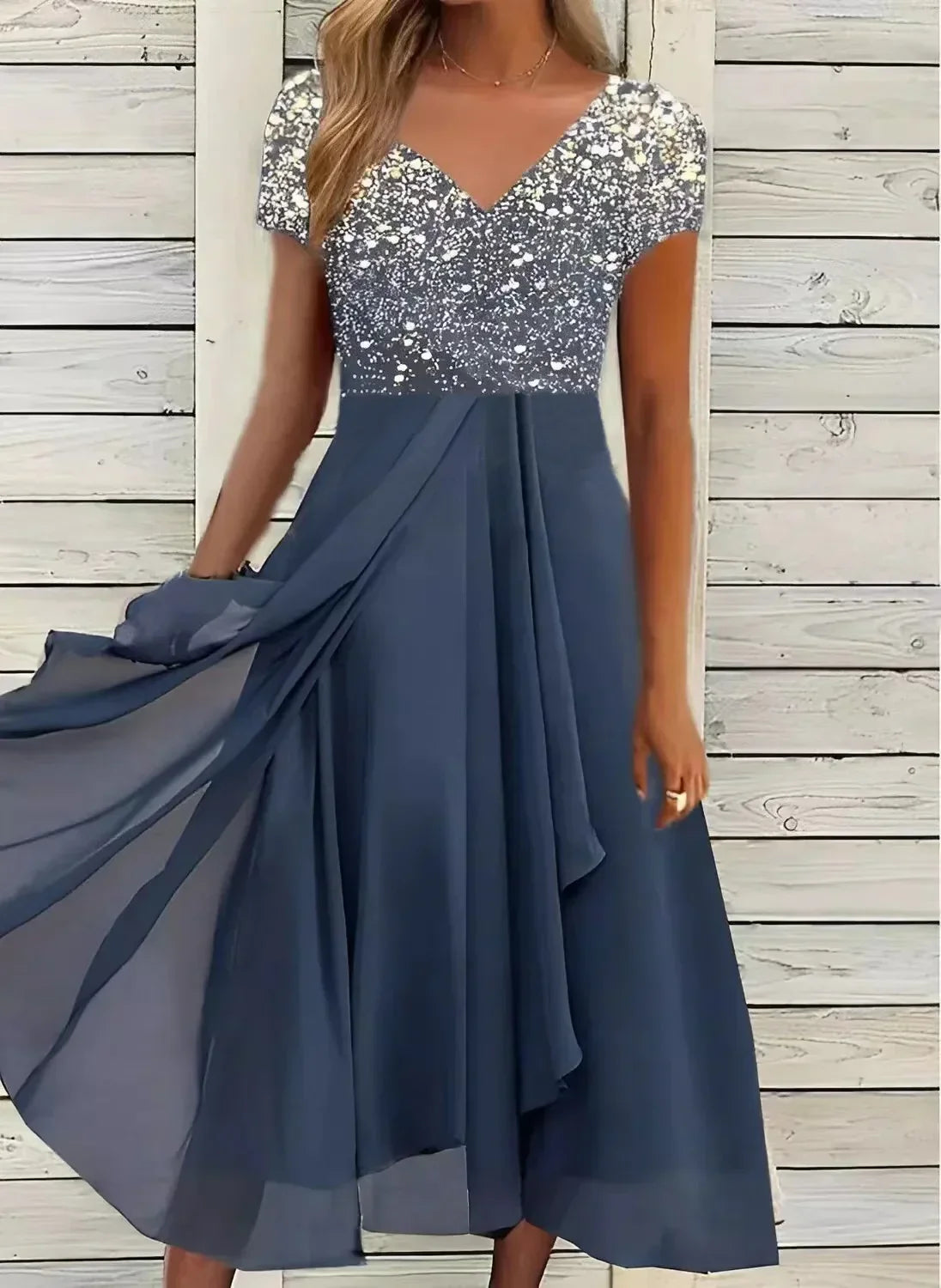 Elegant navy blue evening dress with sequin-embellished bodice, short sleeves, and flowing chiffon skirt, perfect for formal occasions and parties.