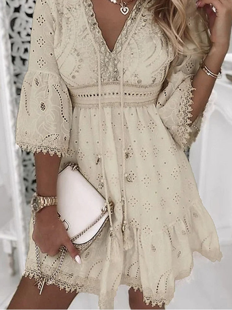 Elegant beige lace dress with intricate embroidery, featuring bell sleeves and a V-neckline. Perfect for summer fashion and boho-chic style enthusiasts.