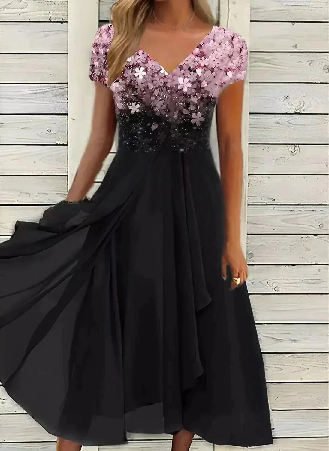 Elegant black evening dress with floral sequin bodice, V-neckline, and flowing skirt, perfect for formal occasions and parties.