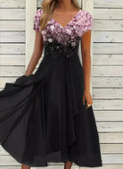 Elegant black evening dress with floral sequin bodice, V-neckline, and flowing skirt, perfect for formal occasions and parties.