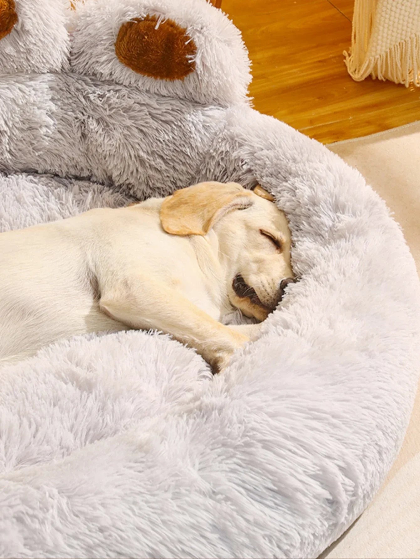Labrador sleeping on plush gray dog bed, cozy pet furniture, fluffy cushion, indoor relaxation.