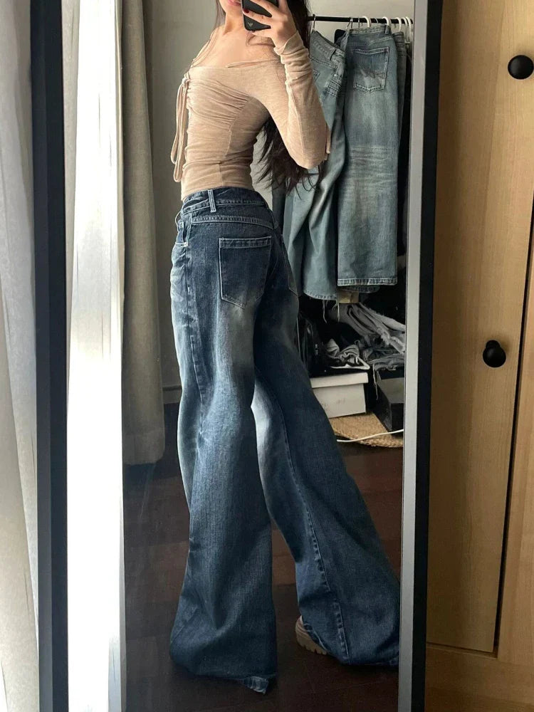 Wide-leg jeans outfit mirror selfie, featuring high-waisted denim pants paired with a beige off-shoulder top. Trendy fashion style for women.