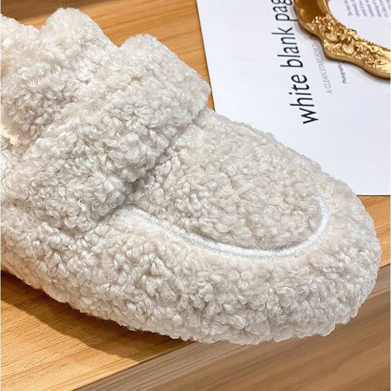 Cozy beige fleece slipper on wooden surface, featuring plush texture and soft design, ideal for indoor comfort and warmth.