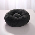 Fluffy dark gray round pet bed on a light surface, ideal for cats and small dogs. Cozy, plush design for comfort and warmth. Perfect pet accessory.