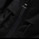 Black waterproof jacket with zipper, close-up view, durable outdoor clothing, high-quality fabric.