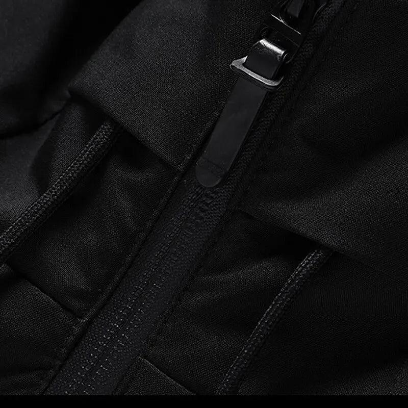 Black waterproof jacket with zipper, close-up view, durable outdoor clothing, high-quality fabric.