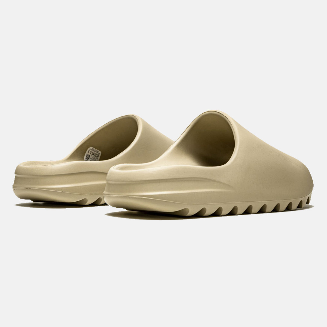 Beige slip-on slides with textured soles, minimalist design, and ergonomic fit. Perfect for casual wear, beach outings, or summer fashion trends.